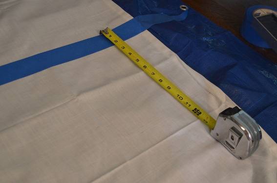 A tape measure being laid out on a tarp.