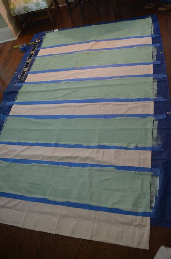 A section of fabric on the ground, it is white blue and green.