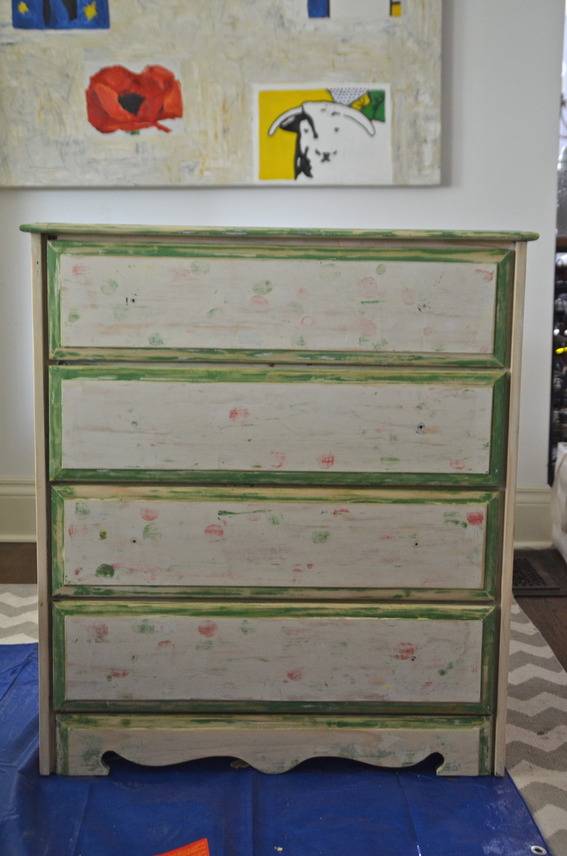 A dresser with hard to see polka dot designs.