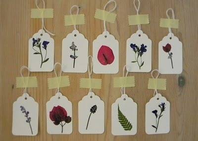 Scalloped rectangular floral themed gift tags each has a string attached to it.