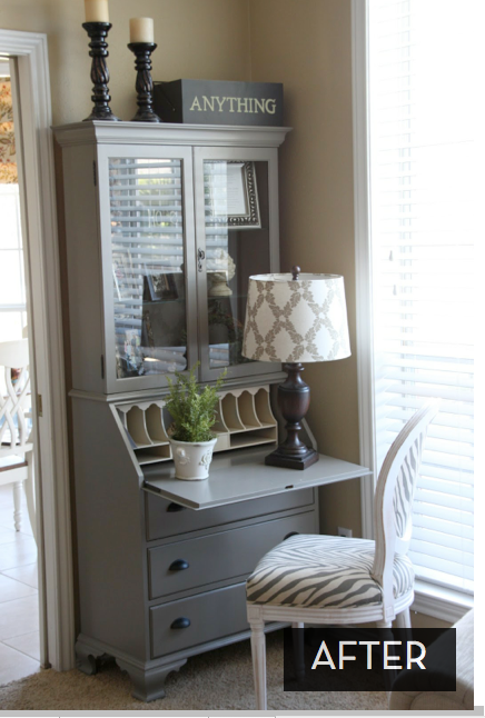 A tall gray cabinet has a lamp, plant and chair next to it.