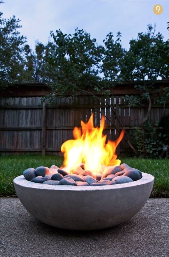A small fire pit that is sitting in the back yard.