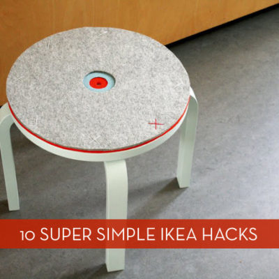 A ikea stool with a gray top.