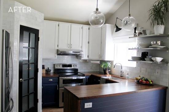 Stove below white cabinets and next to an L-shaped counter in a kitchen.