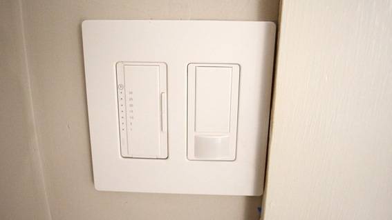 A plain wall with a white double light switch.