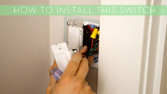 A person installs a light switch where the wires are shown.