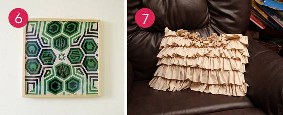 An abstract wall painting and a frilly beige pillow.
