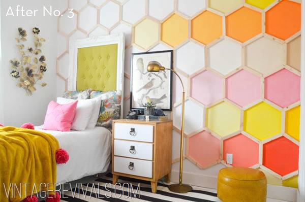 A twin size bed sits against a wall with a bright honeycomb pattern.