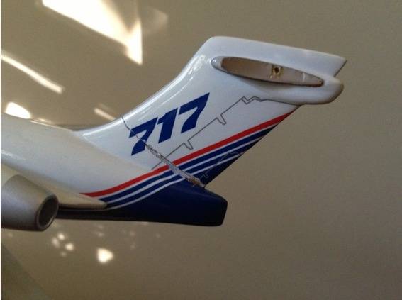 The tail section of a model airplane with numbers on it.