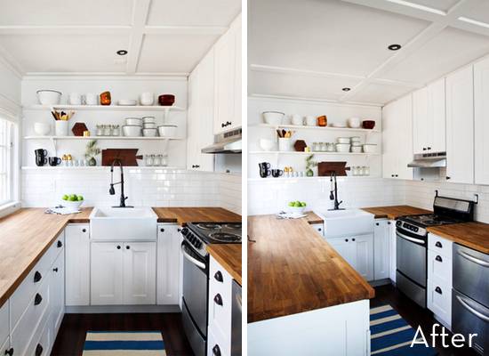 Wooden counters stand out in an white kitchen.