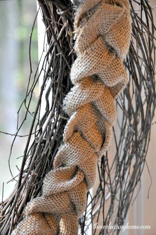 A braided piece of burlap next to twigs.