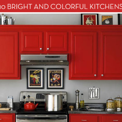 Stove with stockpot and teapot in a kitchen with red cabinets.