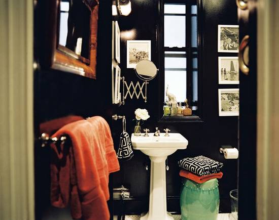 A cluttered bathroom with dark blue walls.