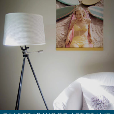 Poster hanger from scrap wood on wall and stand light on bedside table.