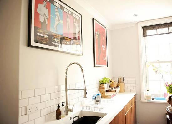 Light feels a bright kitchen with a modern sink and medium colored wood cabinets.