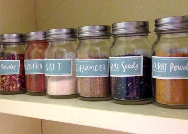 Glass jars with labels and spices in them.