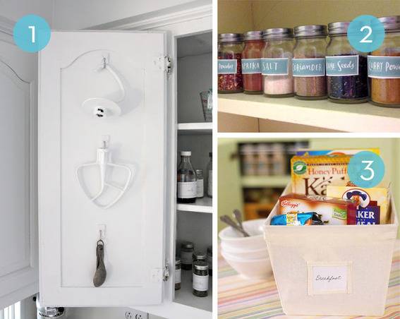 Glass jars are labeled in a cabinet and they have many spices in them.