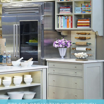 The inside of a very busy kitchen with a steel fridge.