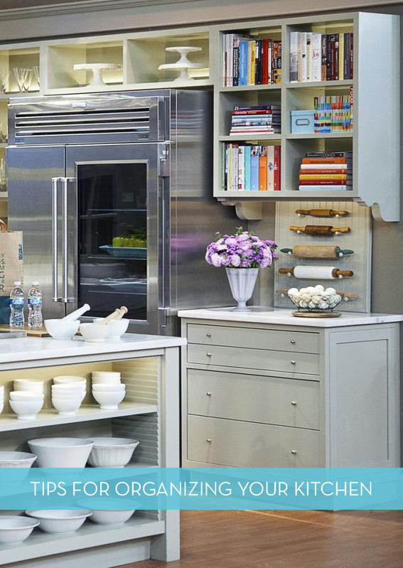 The inside of a very busy kitchen with a steel fridge.