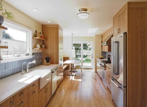 A kitchen with mostly wooden cabinets and counters.