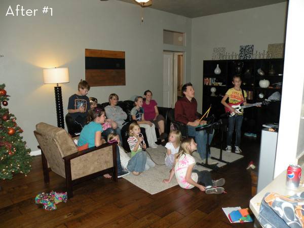 A group of people are playing a music based game in the living room.