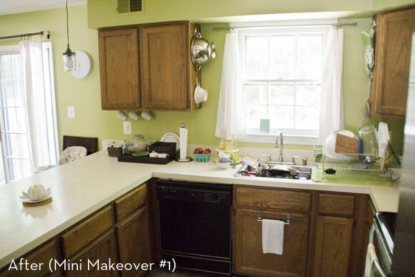 A kitchen has a window over the sink and a U-shaped counter.