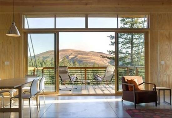 Sliding doors are leading from a living area to an outside deck.