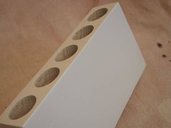 Wood test tube vase in a workshop.