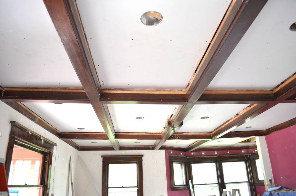 Exposed wood beams on a ceiling in a living room.