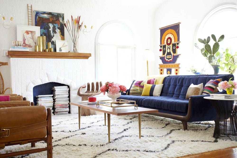 Bouquet of flowers on a coffee table near a sofa in a living room.