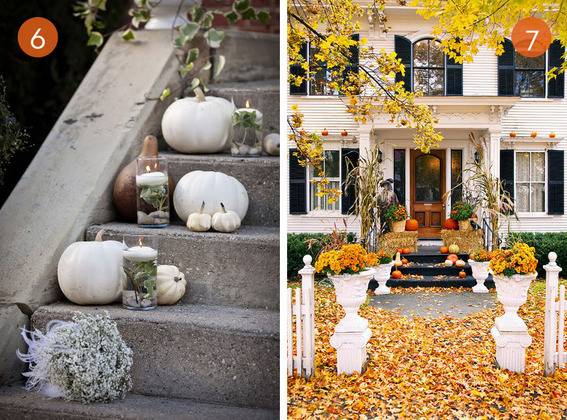 Pumpkins with candles stacked on cement stairs.