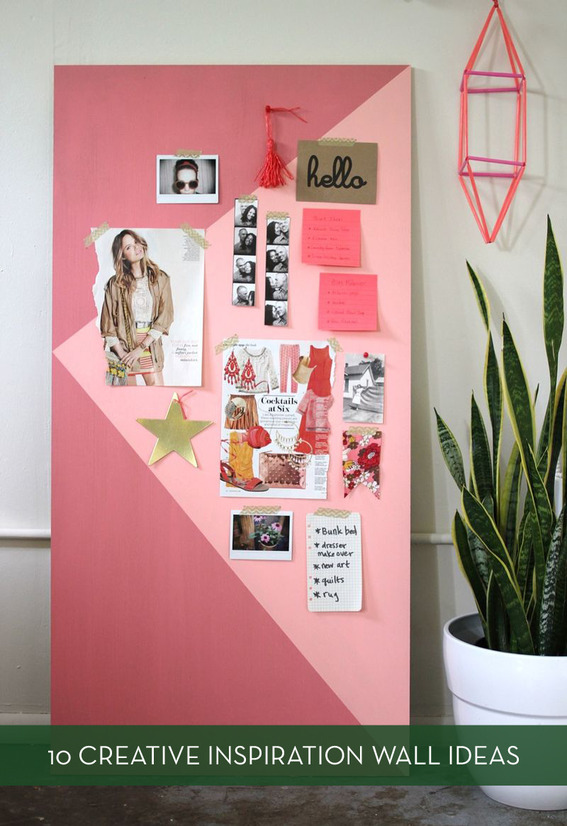Pieces of paper are stuck to a pink board that leans against a wall.