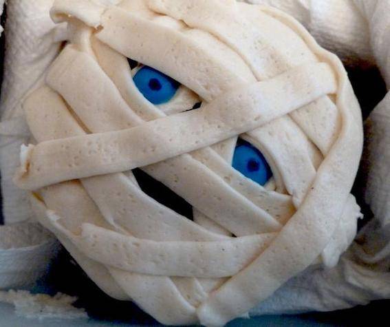 Mummy inspired cupcake with blue eyes.