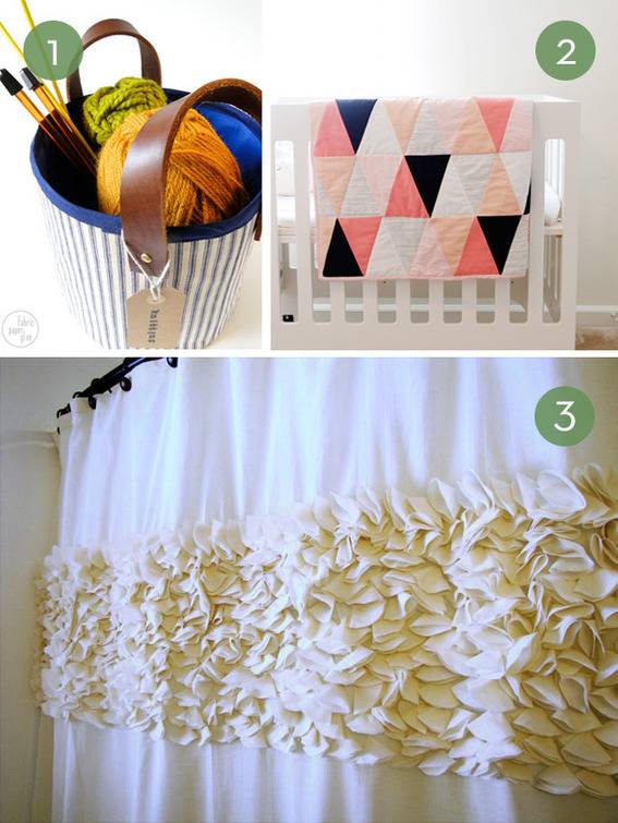 A blue basket of yarn and knitting needles, a crib with a pink, black and white quilt laying over the railing, a curtain with ruffles in the middle.