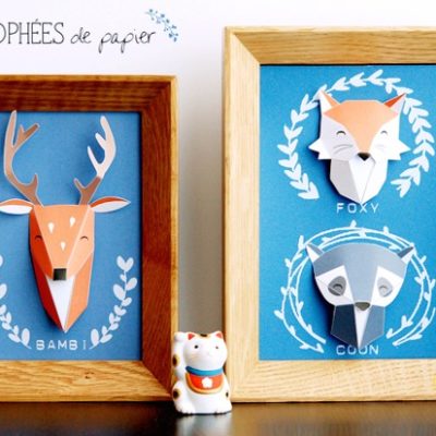 3-D paper deer in picture frame next to 3-D paper fox and raccoon in a picture frame.