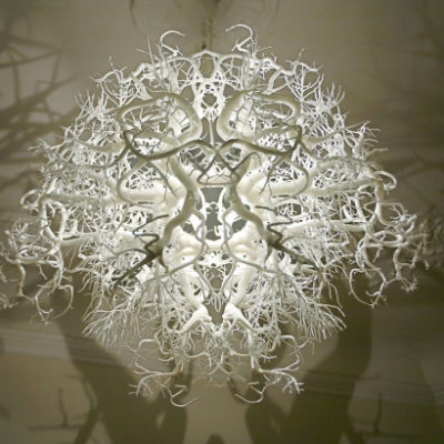 A white ball of jumbled branches has light radiating out from its center.