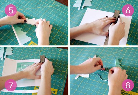 A person measuring and cutting out christmas trees for a christmas card.