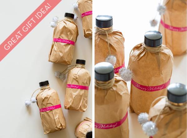 Bottles wrapped with brown paper with pink ribbons and pom pom ribbons.