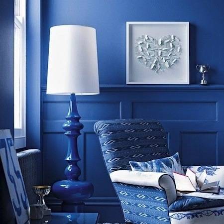 Blue painted room with all blue color things like chair, lamp and table.