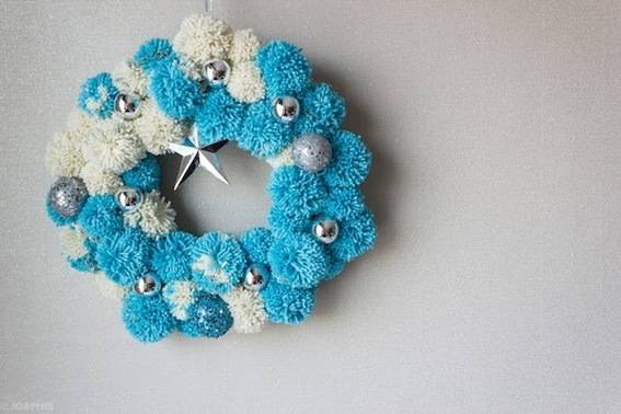 Blue and white pompom wreath with silver balls and a silver star.