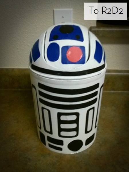 R2D2 trash can sitting on the floor.
