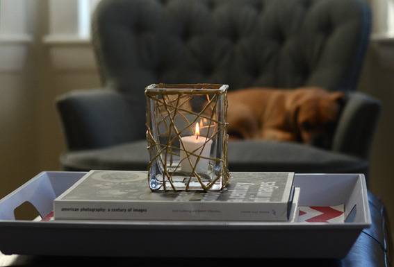 A votive candle resting on a stack of books.