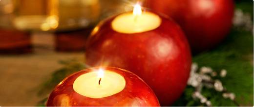 Candles in apple shaped candle holders.