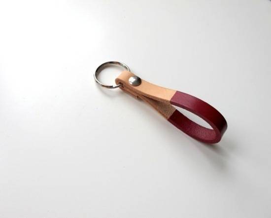 Leather loop key chain with a metal circle.