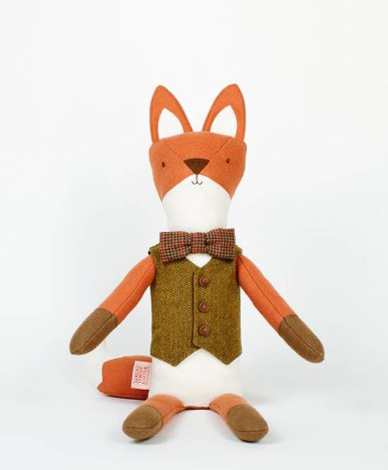 A fox doll made of orange, brown and white cloth.