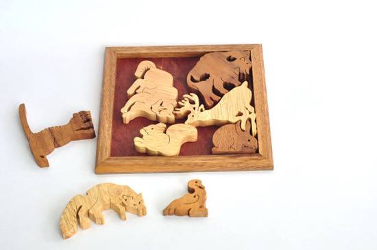 A wooden puzzle where each piece that fits in the frame is an animal
