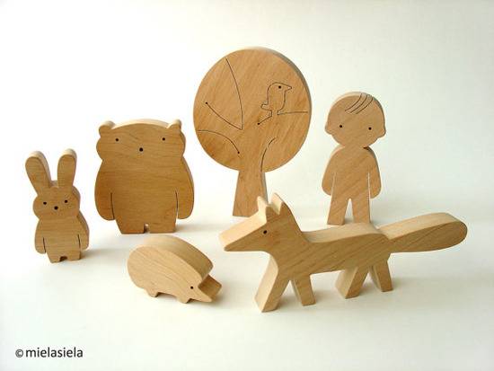 Different characters are cut out of wood.