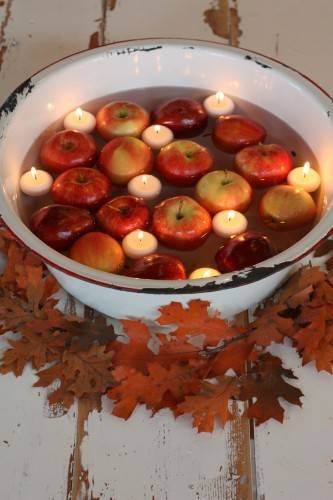 "Water Filled Bowl with candle light and apples to decorate"