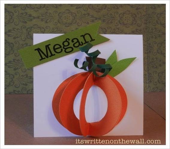 The name Megan is on a pumpkin art craft.