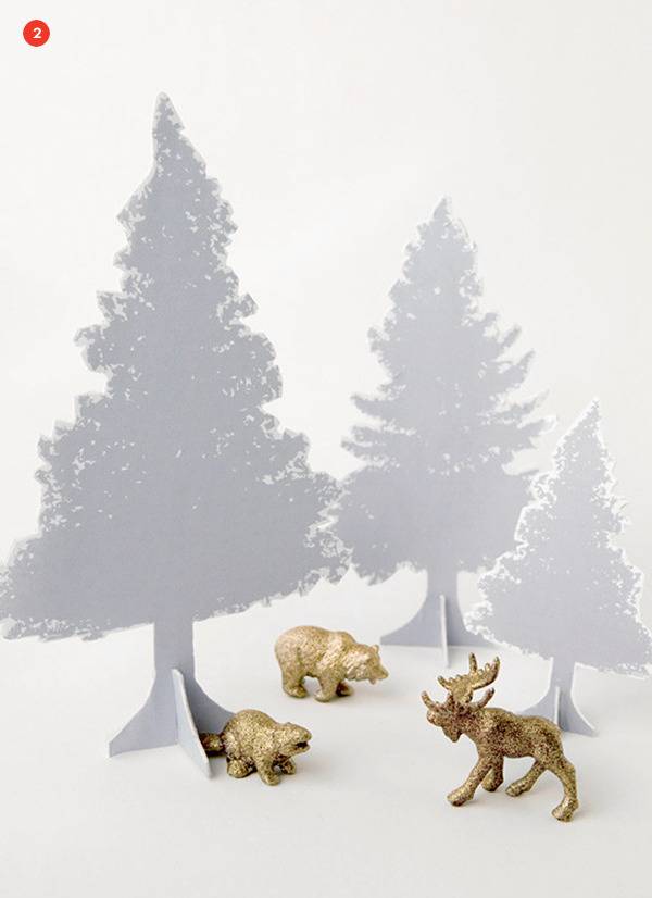 White Christmas trees with three golden animals.